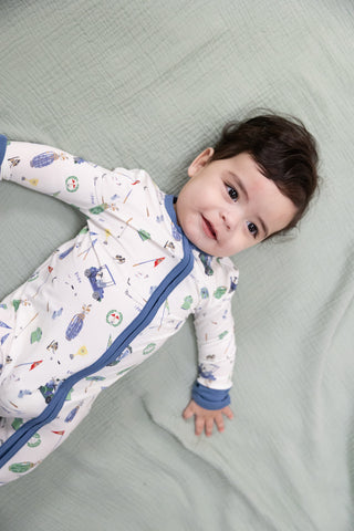 Angel Dear 2 Way Zipper Romper - Golf Things
Child wearing a patterned onesie lying on a gray surface