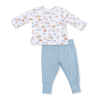 Children's pajama set with patterned top and light blue pants on a white Angel Dear Long Sleeve Henley Play Set - Football Check
background