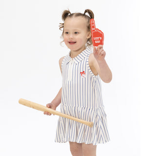 Angel Dear Polo Dress with Cartwheel Short - Baseball Stripe
Child in a striped dress holding a wooden bat and 'Let's Go' sign on a white background