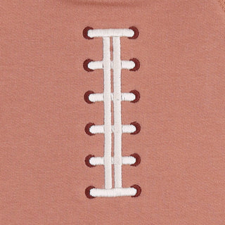 Angel Dear Raglan Sweatshirt and Jogger Set - Football Laces
Close-up of a dusty rose pink fabric garment featuring a white embroidered football lacing pattern down the center.