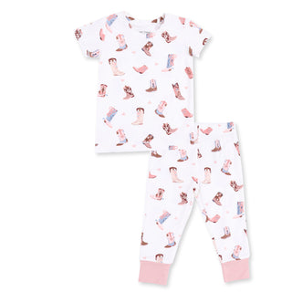 Angel Dear Short Sleeve Loungewear Set - Buckarette Boots
A two-piece children's pajama set featuring a short-sleeve top and matching pants. The white fabric is decorated with a repeating pattern of cowboy boots in pink, blue, and brown, with solid light pink ribbed cuffs on the pants.