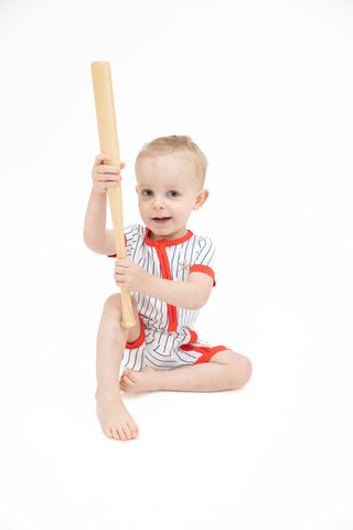 Angel Dear Shortie 2 Way Zipper Romper - Baseball Stripe
Child in a baseball uniform holding a bat on a white background