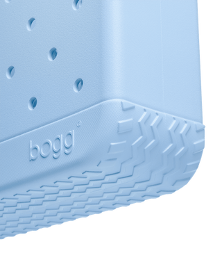 Baby Bogg Bag - Blue Skies and Bogg Bag
Close-up of a blue plastic product with 'bogg' branding on a green background