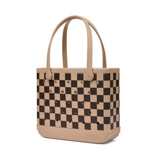Baby Bogg Bag - Checkered: Camel / Hot Cocoa
A structured tote bag with a beige and dark brown checkerboard pattern, featuring circular cutouts in the squares and dual top handles, shown on a plain white background.