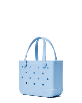 Bitty Bogg® Bag - Blue Skies and Bogg Bag
Light blue handbag with perforated design on a transparent background