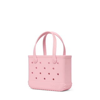 Bitty Bogg® Bag - Blush-Worthy
A light pink silicone tote bag with integrated handles and ventilation holes, shown on a plain white background.