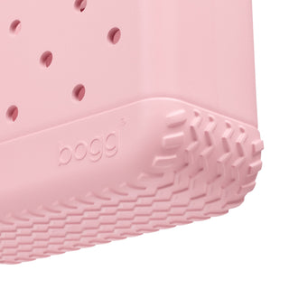 Bitty Bogg® Bag - Blush-Worthy
Close-up of a pink Bogg product corner showing a textured treaded bottom edge and the embossed Bogg brand name on a white background.