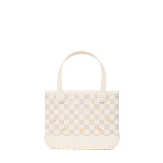 Bitty Bogg® Bag - Checkered: Coconut / Mushroom
A small tote bag with a cream and light beige checkerboard pattern and scattered gold polka dots, featuring two top handles and a cream-colored base, shown against a plain white background.
