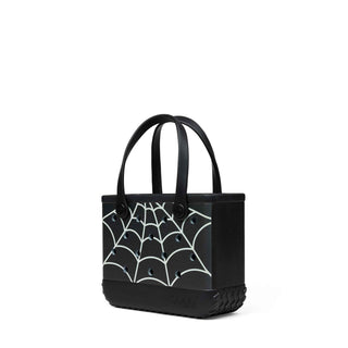 Bitty Bogg® Bag - Itsy Bitsy Glow in the Dark
A black tote bag with a white spiderweb pattern and small rhinestone accents, featuring dual top handles and a textured base, shown on a plain white background.