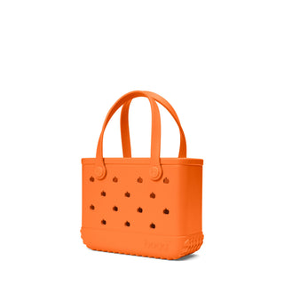 Bitty Bogg® Bag - Pieces of Pumpkin
An orange silicone tote bag with integrated handles, decorative cutout details, and a textured base, shown on a plain white background.