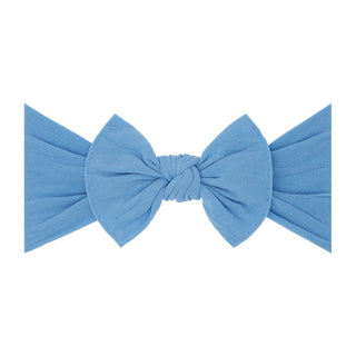 Baby Bling denim knot headband with classic bow design, soft and stretchy fabric for comfortable baby girl accessory.