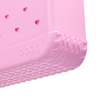 Baby Bogg® Bag - In Love With Bogg - Pink Taffy
Close-up of a pink children's shoe sole with heart patterns and 'Boggs' branding.