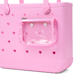Baby Bogg® Bag - In Love With Bogg - Pink Taffy
Pink pet carrier with heart patterns and a clear front panel on a white background