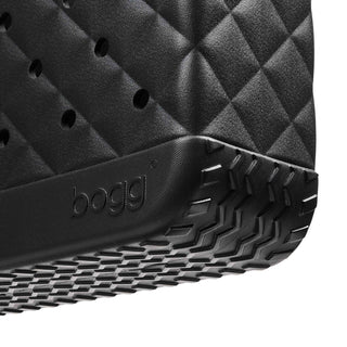 Baby Bogg® Bag - Quilted LBD Black
Close-up of a black textured shoe sole with 'bogg' branding on a white background