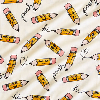 Posh Peanut Posh Pencils Ruffled Twirl Dress Pattern of cartoon pencils with facial expressions and text on a beige background