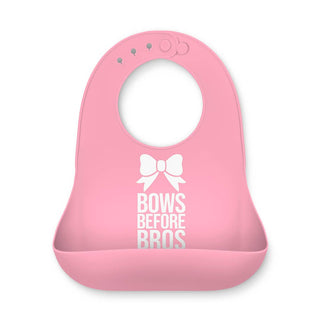 Bella Tunno Fun Wonder Bib - Bows Before Bros
A pink silicone baby bib with a white bow graphic and the text 'BOWS BEFORE BROS' printed on the front, set against a plain white background.