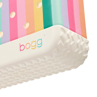 Bitty Bogg® Bag - Liquid Sunshine - Color Burst
Close-up of a white textured container with 'bogg' branding against a colorful striped background.