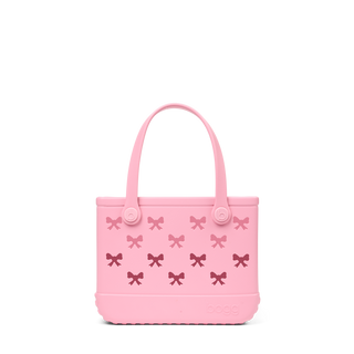 Bitty Bogg® Bag - Bubblegum Bows 
Pink handbag with bow patterns on a white background