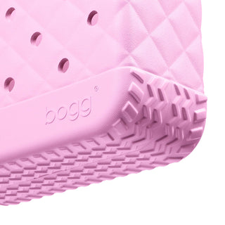 Bitty Bougie Bogg® Bag - Quilted Pink Taffy
Close-up of a pink rubber sandal sole with 'bogg' branding on a white background