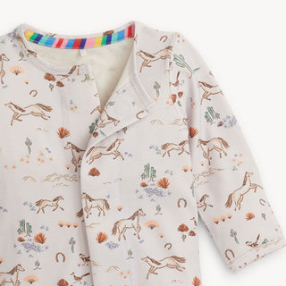 Magnetic Me Born To Run Modal Footie Children's outfit with horse pattern and rainbow trim on a white background