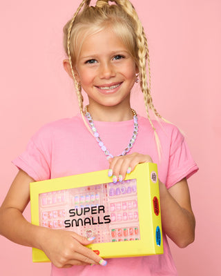 Super Smalls Heartfelt Press On Nail Kit
Young girl holding a 'Super Smalls' product box against a pink background