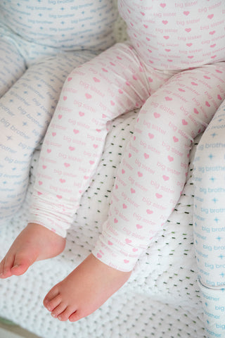 The Uptown Baby bamboo long sleeve romper for big sister, featuring soft fabric and comfortable fit, shown on a child.