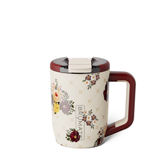 Brumate Müv 15oz - Quilted Florals 
A floral-patterned insulated mug with a cream body, dark red handle and lid, and a diamond lattice design with small floral accents. The word 'BRUMATE' is printed vertically on the front.