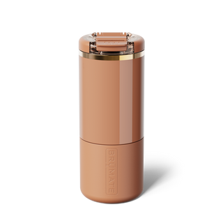 Brumate Strova 18oz - Biscotti
A tall, cylindrical travel tumbler in a warm terracotta brown color, featuring a matching flip-top lid with a metallic gold accent band and the embossed brand name 'BRUNATE' on the lower half.
