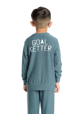 Chaser Goal Getter Long Sleeve Pullover
Child wearing a teal outfit with 'GOAL GETTER' text on the back against a white background