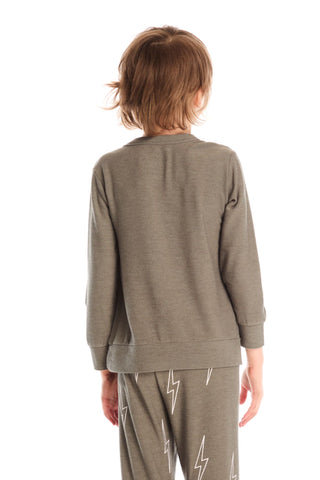 Chaser Bolt Long Sleeve
Child wearing a green tracksuit with lightning bolt designs on a white background