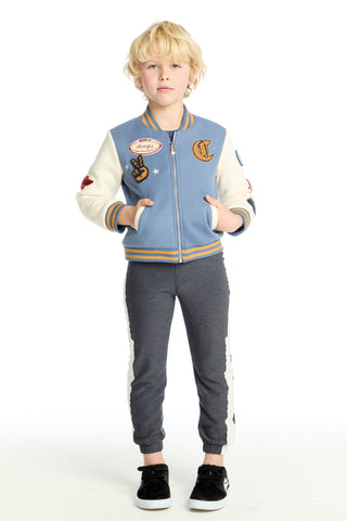 Chaser Steel Blue and Stonewash Blue Jacket Child wearing a varsity jacket with patches and gray pants on a white background