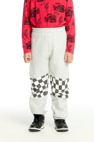 Chaser Checker Colorblock Pants
Person wearing a red patterned shirt and white pants with checkered design on a white background