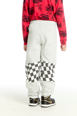 Chaser Checker Colorblock Pants
Person wearing a red patterned shirt and white pants with a checkered design, standing against a white background.