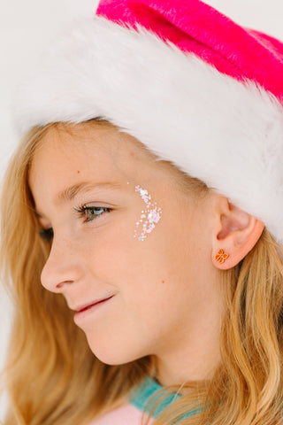 Pierced Co. Red Bow Earrings
Close-up of a person wearing a festive hat with pink and white colors.