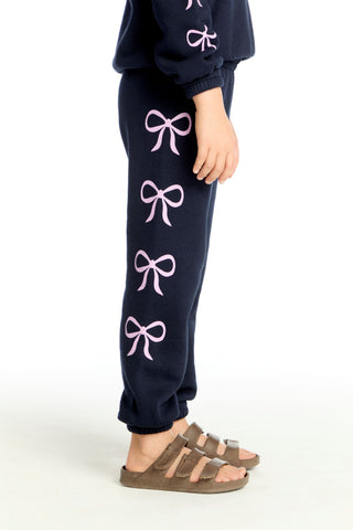 Chaser Shirred Easy Stormy Bows Sweatpant
Navy sweatpants with pink bows worn by a person on a white background