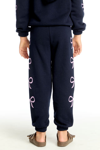 Chaser Shirred Easy Stormy Bows Sweatpant
Navy blue sweatpants with pink symbols on a white background