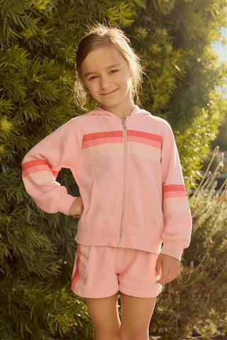 Chaser Multi Stripes Girls Zip Up
Young girl wearing a pink tracksuit standing outdoors with greenery in the background