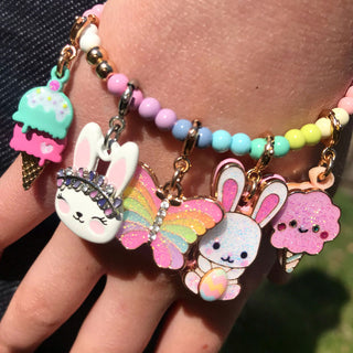 Charm It! Gold Easter Bunny Charm
Colorful bracelets with cartoon character charms on a person's wrist.