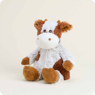 Cinnamon Latte Cow Warmies
Plush cow toy with brown and white fur on a light beige background