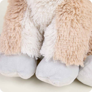 Goat Warmies
Close-up of fluffy socks with pink and white fur and gray toes on a light background