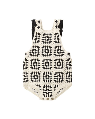 Rylee & Cru abstract crochet romper displayed on a hanger, showcasing intricate crochet details and vibrant pattern.