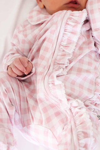 Caden Lane Peter Pan Collar Ruffle Zipper Footie - Rosy Gingham
Baby wrapped in a pink checkered blanket