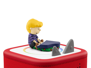 Tonies Character: Peanuts: A Charlie Brown Christmas (Vince Guaraldi Trio)
Toy figure of a child playing with a toy car on a red toy set with a white background