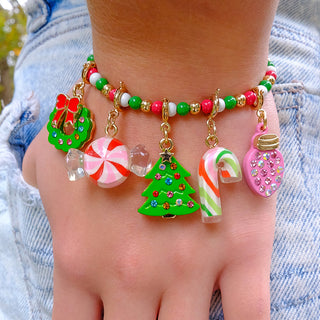 Charm It! Gold Christmas Light Charm
Colorful beaded bracelet with Christmas-themed charms on a wrist against a denim background