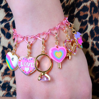 Charm It! Gold Heart Lollipop Charm
Colorful bracelet with heart-shaped charms on a wrist against a leopard print background