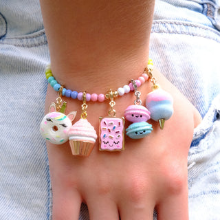 Charm It! Gold Toaster Cake Charm
Colorful bracelet with various charms on a wrist against a denim background