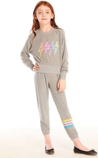 Chaser Contrast Strappings Pants
Girl wearing a gray sweatshirt and pants with colorful accents on a white background