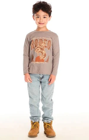 Chaser Hold Your Horses Long Sleeve
Child wearing a long-sleeve shirt with a graphic design, light blue jeans, and brown boots on a white background