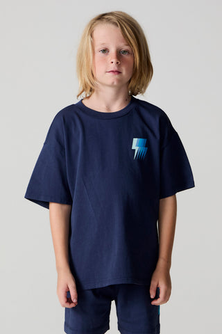 Chaser Multi Bolt Tee
Child wearing a navy blue t-shirt with a small logo on a plain background