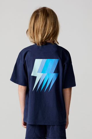 Chaser Multi Bolt Tee
Child wearing a navy blue t-shirt with a blue lightning bolt design on the back against a plain background